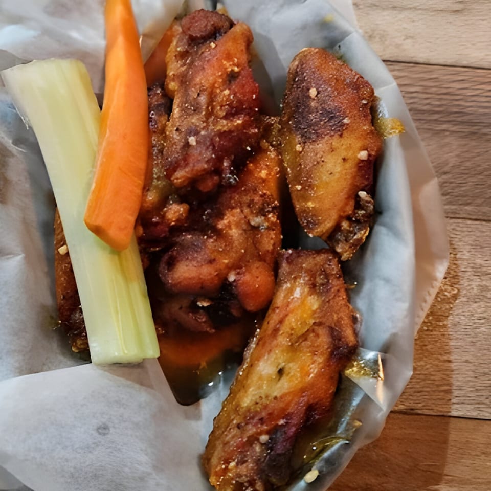 Kings Roadhouse Bar & Grill's crispy chicken wings with celery and carrot sticks in a basket.